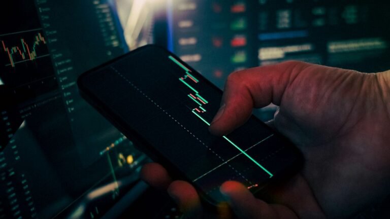 Unlocking the Benefits of Fintech: A Modern Financial Revolution Trader analyzing stock market data on smartphone and phone