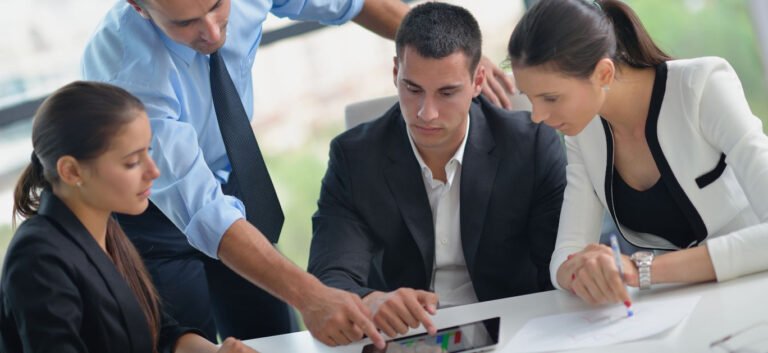 Group of happy young business people in a meeting at office