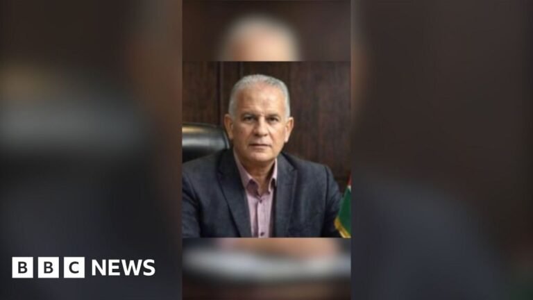 Mohammed Al-Wahidi has short grey hair. He is wearing a dark suit jacket and a pale pink shirt.