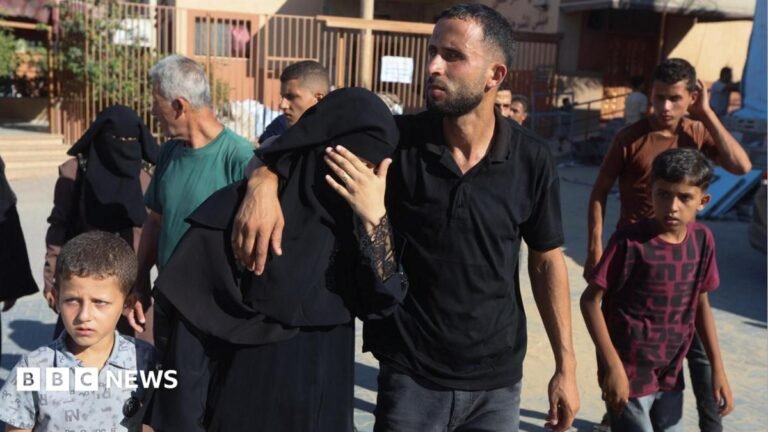 The mother of Amal Abu Khater, 10, is comforted outside Nasser hospital, in Khan Younis, southern Gaza (24 August 2026)