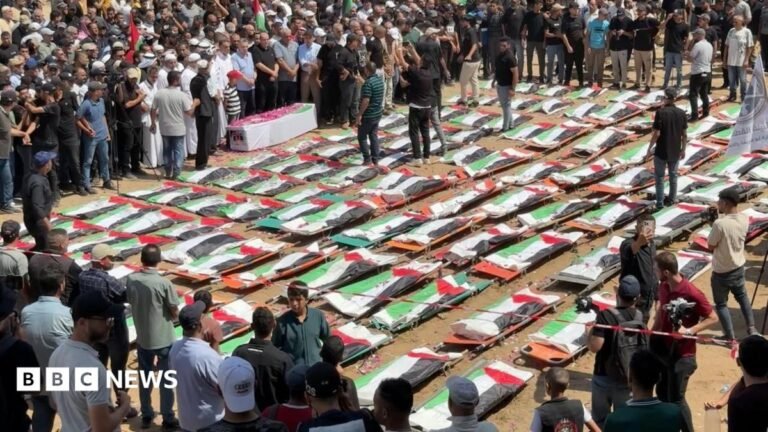 Mass funeral in Gaza for 112 Palestinians killed in 2023 Israeli strike Palestinian flags and photographs are laid over bags containing the remains of 112 members of the Hassayna and Abu Sharia clans who the Civil Defence says were killed in an Israeli strike in November 2023, at a mass funeral in Gaza City, northern Gaza (4 August 2026)