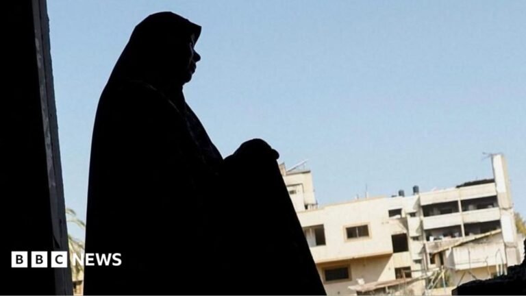 Reports of violence against women in Gaza surge, UN agency finds A file photo showing a Palestinian woman inspecting her damaged home after an Israeli strike on a nearby mosque, in Gaza City (29 July 2026)