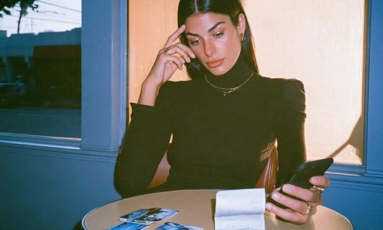 The Quiet Money Habits That Separate Savers From Spenders A woman looking at what money she has saved and what she can spend to purchase things